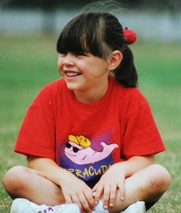 Smiling child in a Barracudas kids camp tshirt